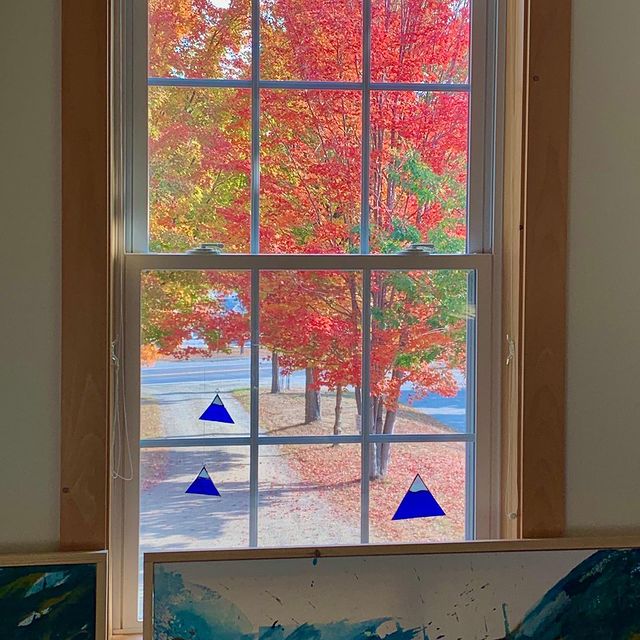 View from our Kingfield, Maine studio this morning. Jess Beer’s paintings in the foreground (waiting to be photographed) and Pat Pray’s Sugarloaf glass pendants hanging in the window. #orcuttphotography #kingfieldmaine #schoolhousestudio #jessbeerpainting #patprayglasswork