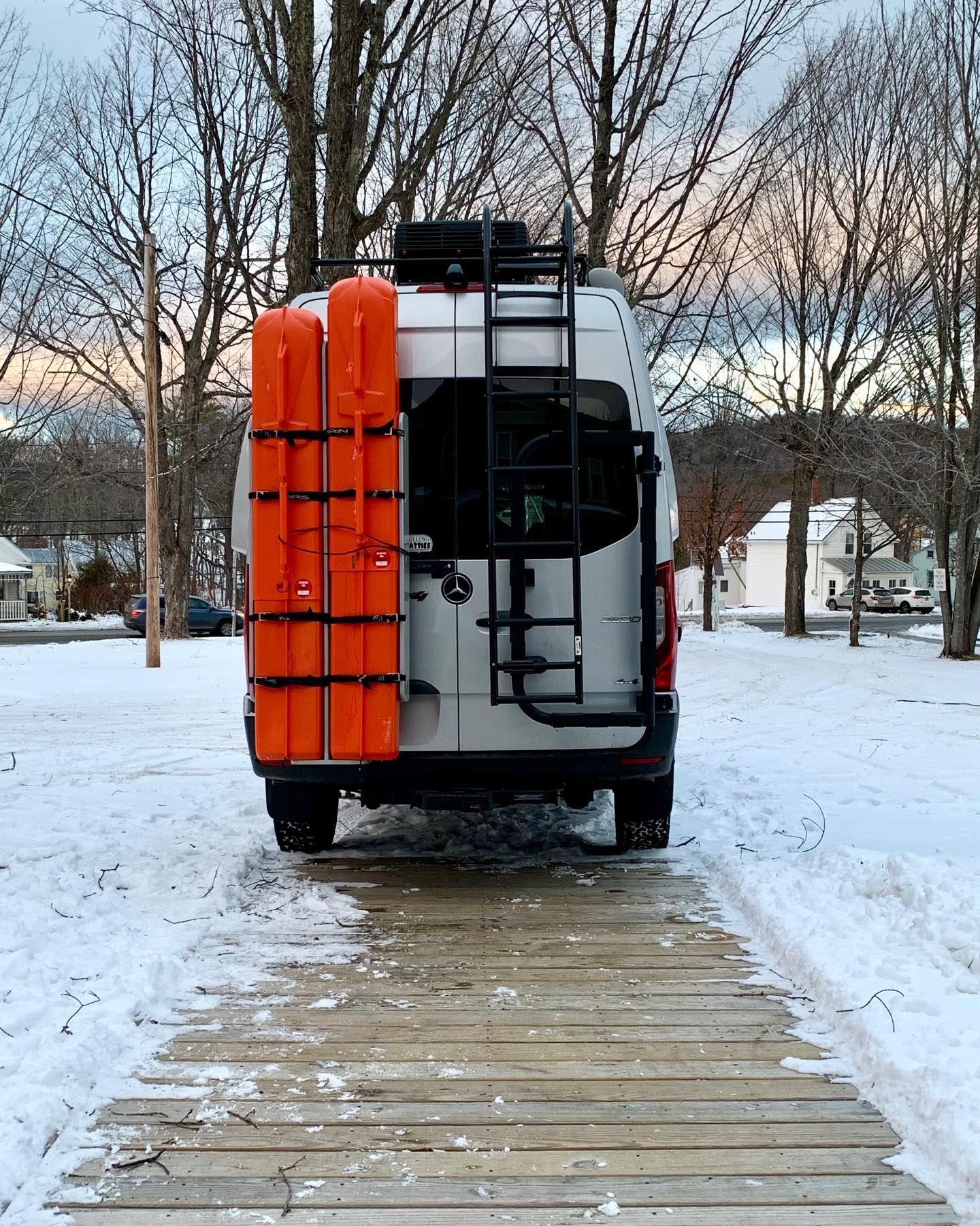 Sprinter all packed and ready to head west from Kingfield, Maine. Destination Idaho with 7 pairs of skis in the orange Sport Tubes attached to the Owl Engineering Sherpa on the back door. #vanlife #gnarvan #owlengineering #sporttube #sprintervan #awoladventurerigs #orcuttphotography #rollingfatties