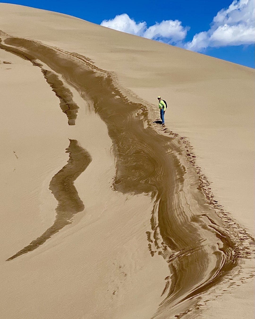 Cindy Orcutt making her way up the last ridge to one of the highest dunes in Sand Dunes National Park today. The scale of this extraordinary landscape is overwhelming. Great place for photography. #greatsanddunesnationalpark #orcuttphotography.com #climbingthedunes