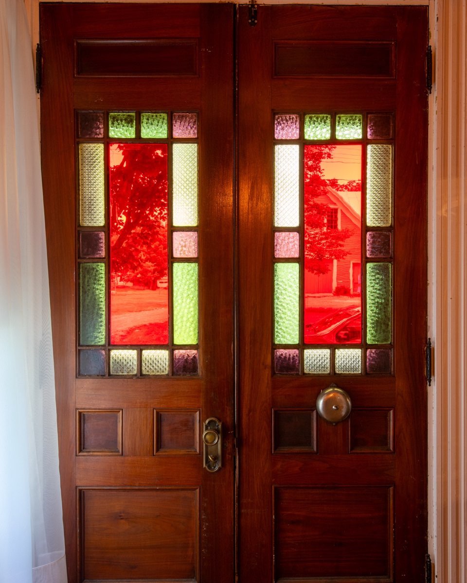 Front door of the Frank and Effie Hutchins House, home of the Kingfield, Maine Historical Society. The house has been on the National Register of Historic Places since 1986. The Kingfield Historic House will be open for the 2022 season on Wednesday, June 1, and every Wednesday  from 10:00 to 2:00, until October 19. #kingfieldhistoricsociety #kingfieldhistorichouse #kingfieldmaine #orcuttphotography #artglassdoor