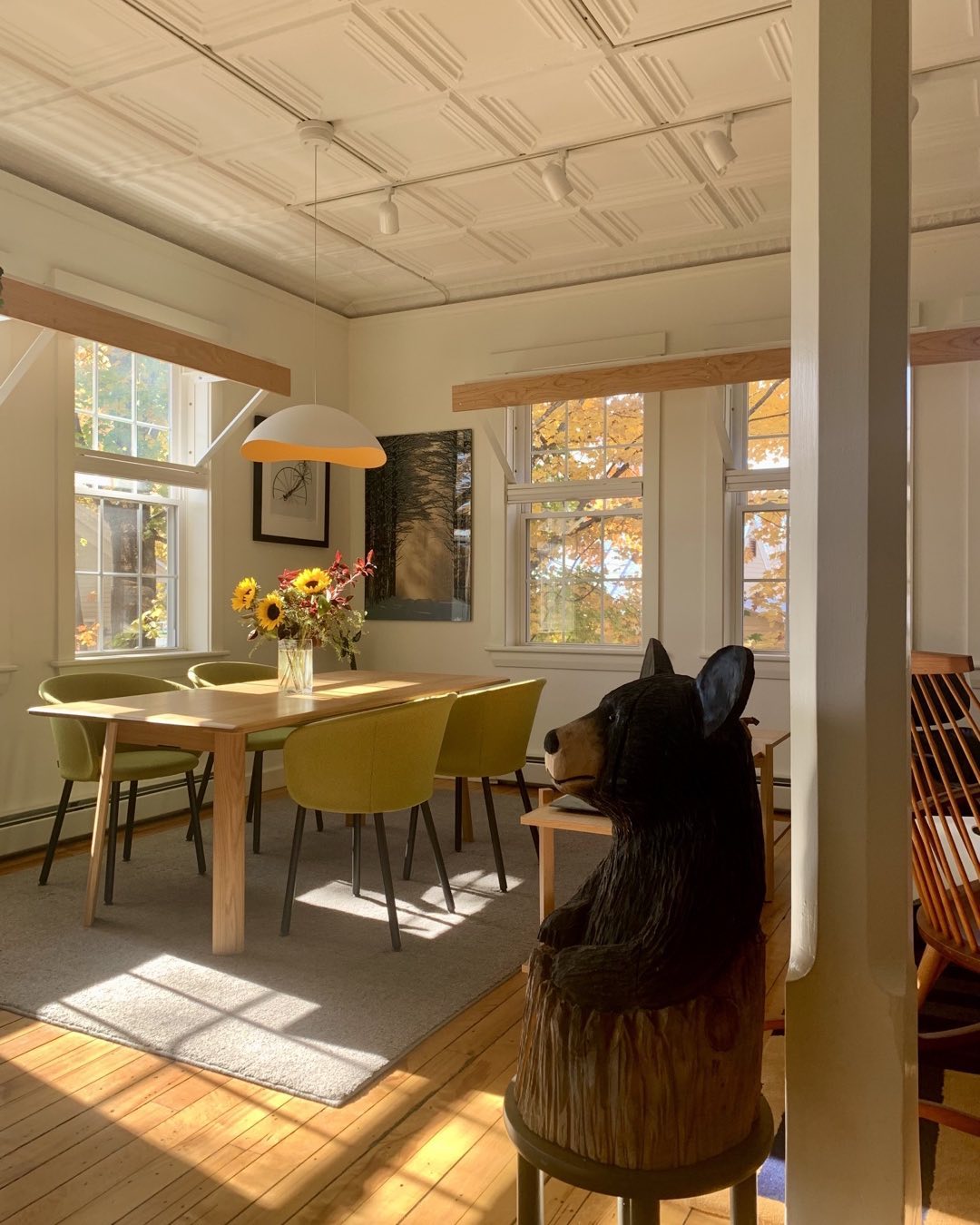 The interior of our Schoolhouse residence in Kingfield, Maine is made more comfortable by the presence of this little fellow. Carved by chainsaw artist, Brad Clark from North Anson, Maine, it greets us as we enter the open living room. #kingfieldmaine #bradclarkchainsawartist #blackbear #orcuttphotography #schoolhouseart