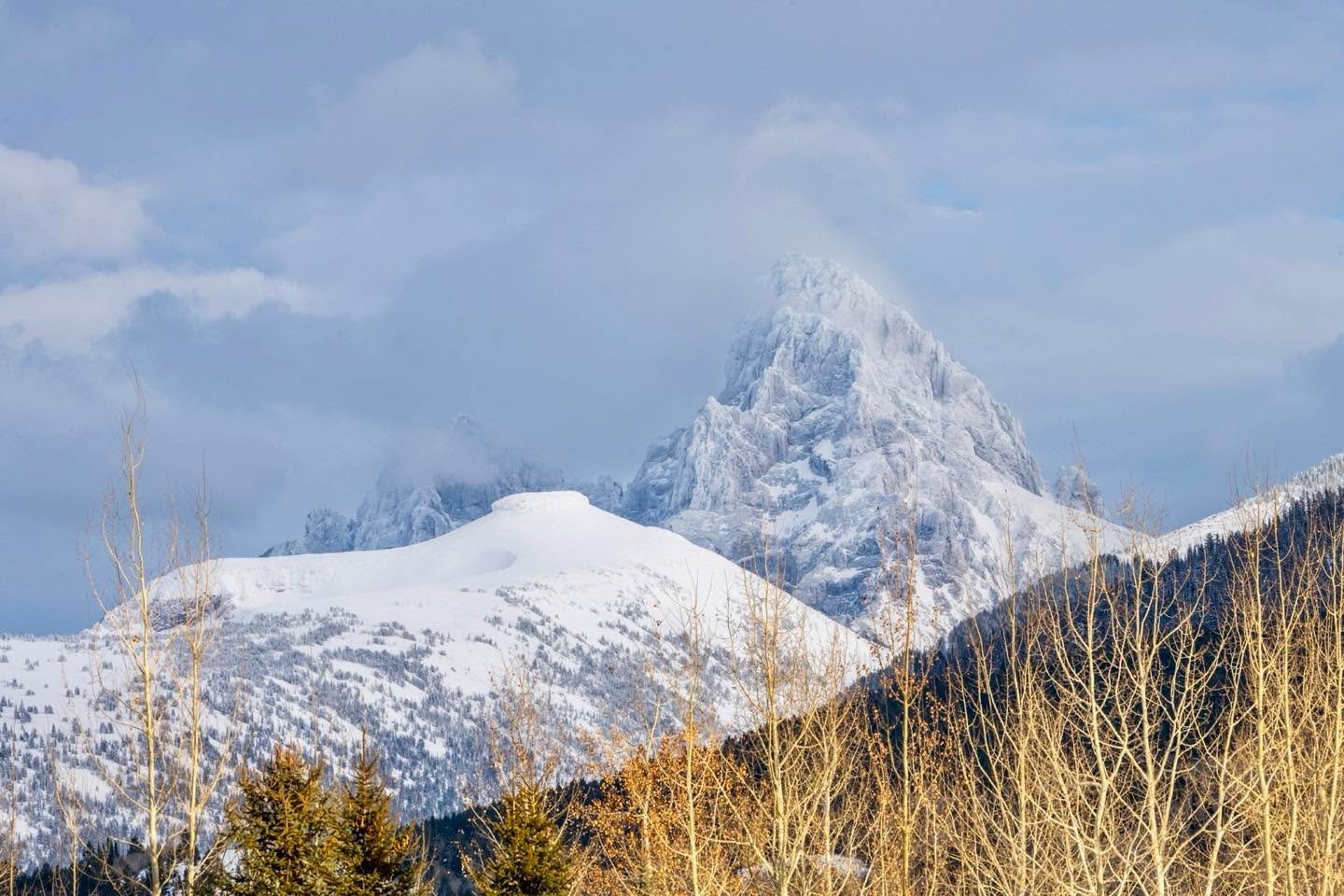 Table Mountain with the Grand Teton behind it is fully illuminated by low afternoon sunlight. This view is from our home in Teton Valley, Idaho